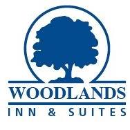 Woodlands Inn & Suites logo